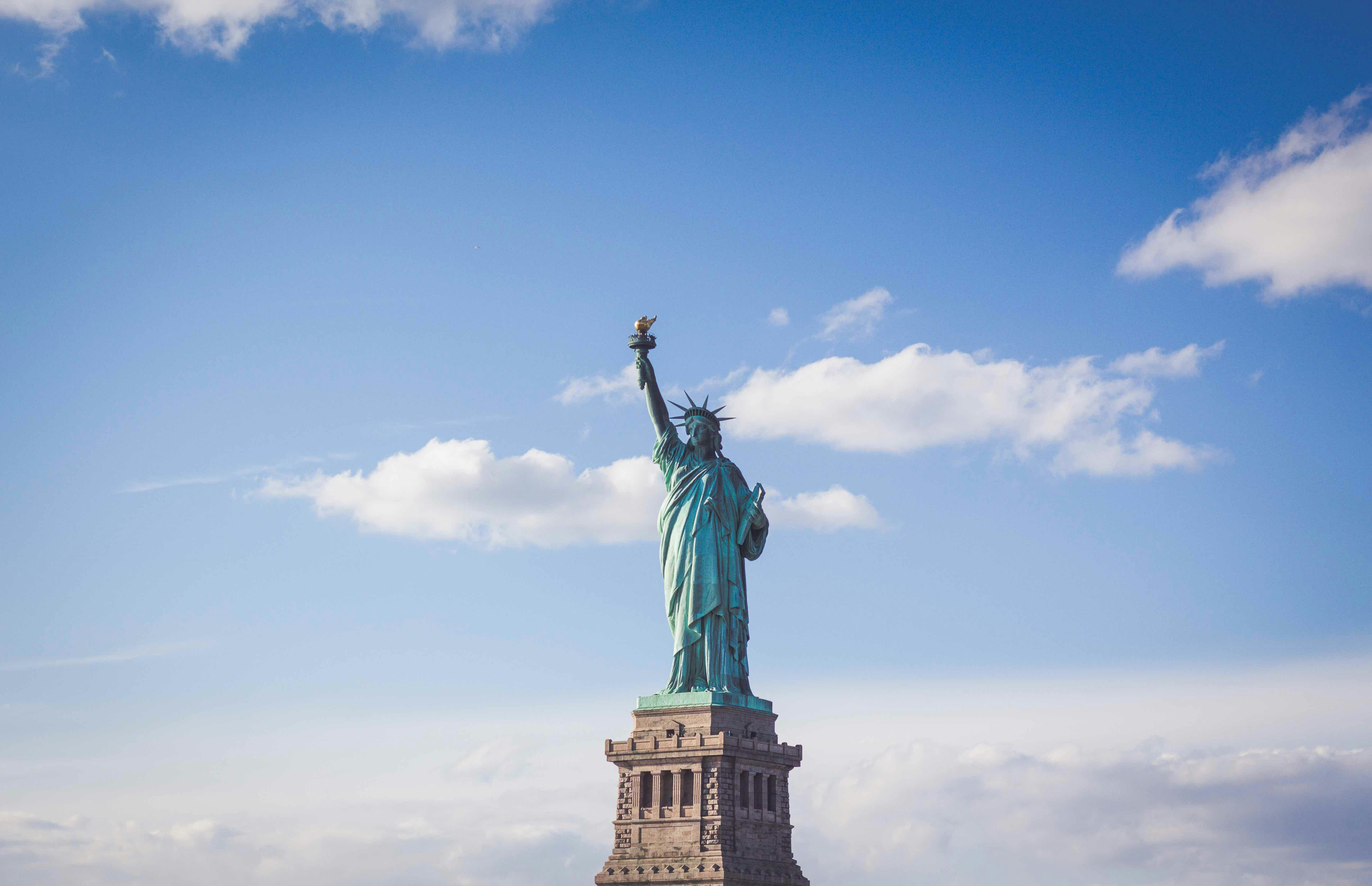 Statue of Liberty under a bright blue sky